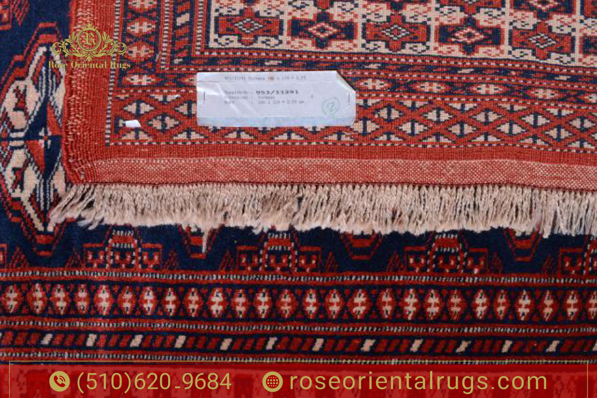 Close-up of a hand touching a Persian rug with visible fiber texture, showing effects of humidity.