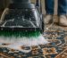 Master artisan gently hand-washing a vibrant, intricate Persian rug with a soft brush and rich organic lather, showcasing expert Iranian carpet cleaning in Berkeley.