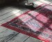 pecialized rug and carpet cleaning Berkeley technicians washing a hand-knotted wool rug with gentle brushes in a wash pit.
