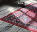 pecialized rug and carpet cleaning Berkeley technicians washing a hand-knotted wool rug with gentle brushes in a wash pit.