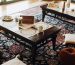 Detailed edge binding and stitched fabric border on custom bound carpet rugs over hardwood flooring.